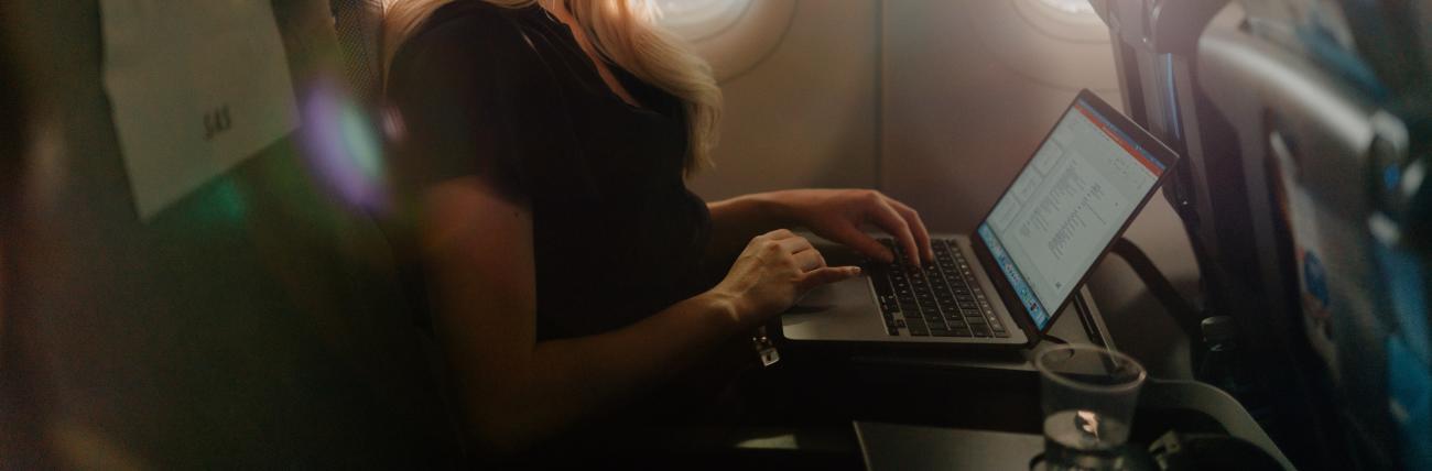 Female traveler using WiFi on board