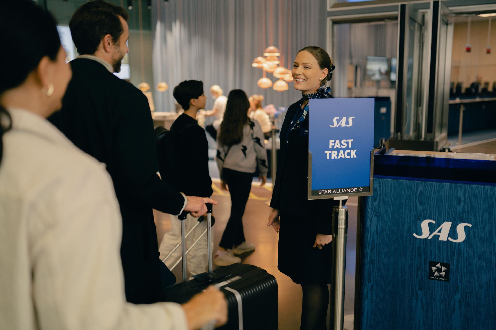 People pass through airport fast track