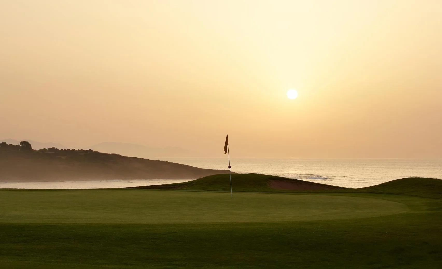 Golf green in sunset