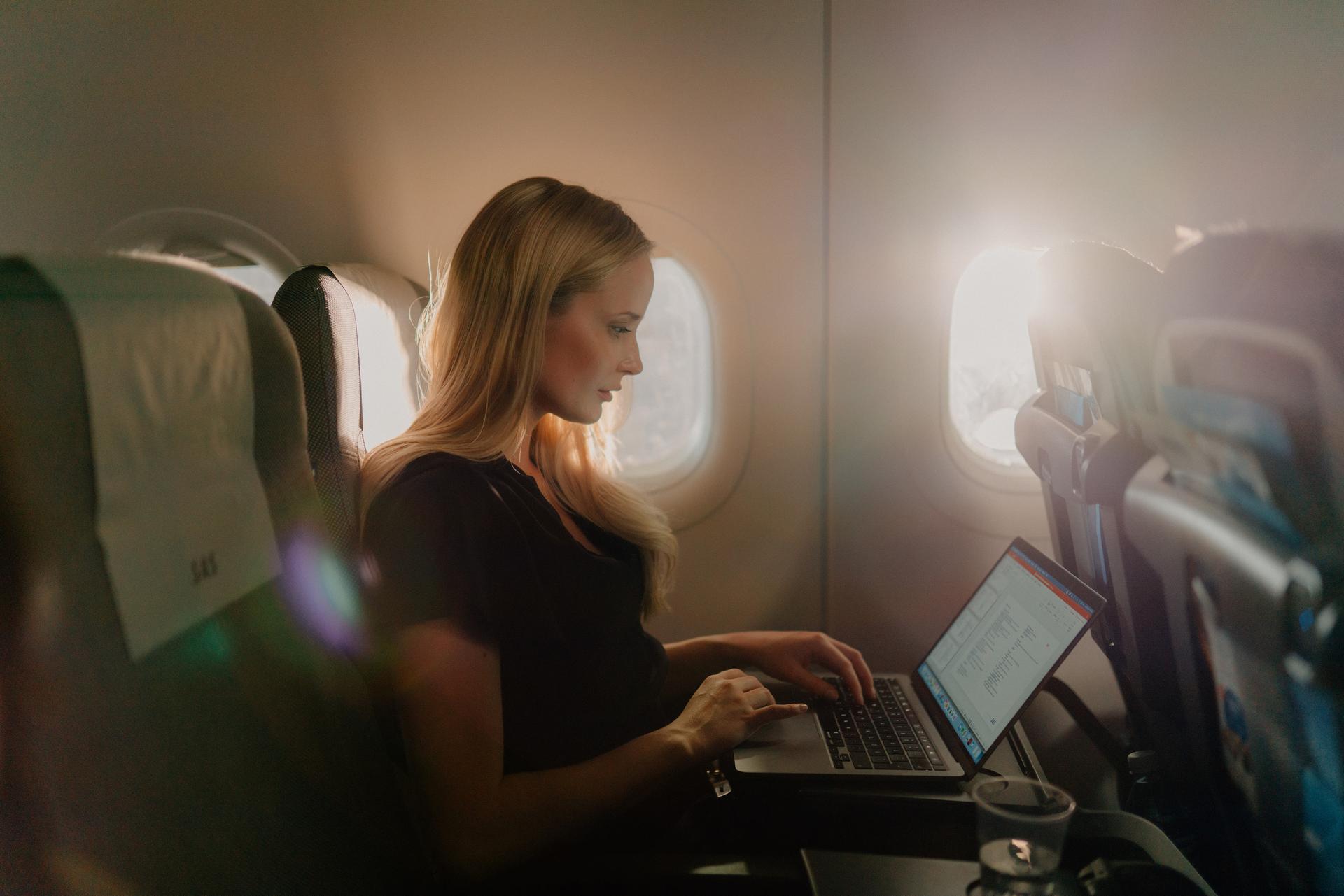 Female traveler using WiFi on board